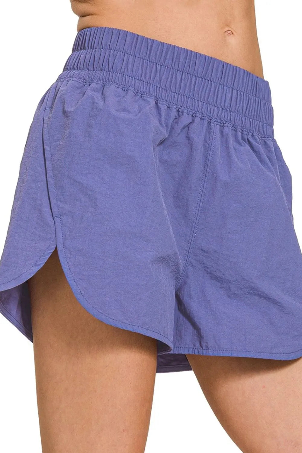 Woman wearing the Her Femme Fit Windbreaker Running Shorts in Marlin Blue