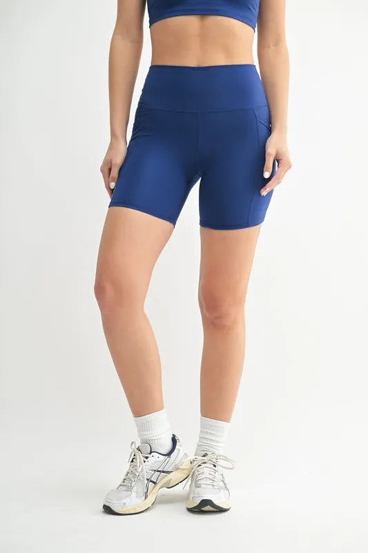 Woman wearing the Her Femme Fit Cloud Sculpt Biker Shorts in Deep Blue