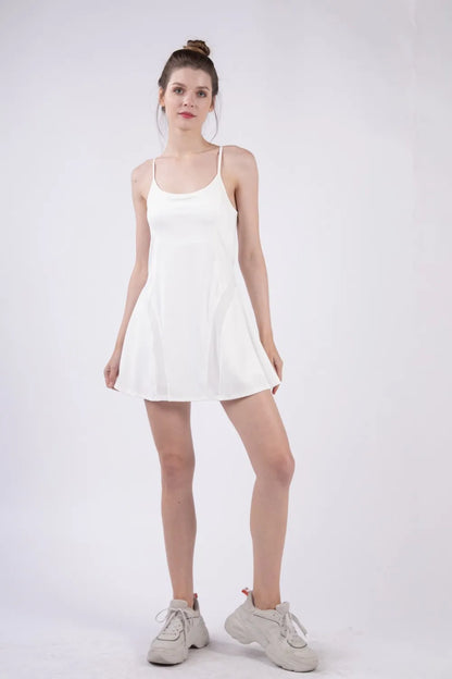 Woman wearing the Her Femme Fit Mesh Panel Tennis Dress in White