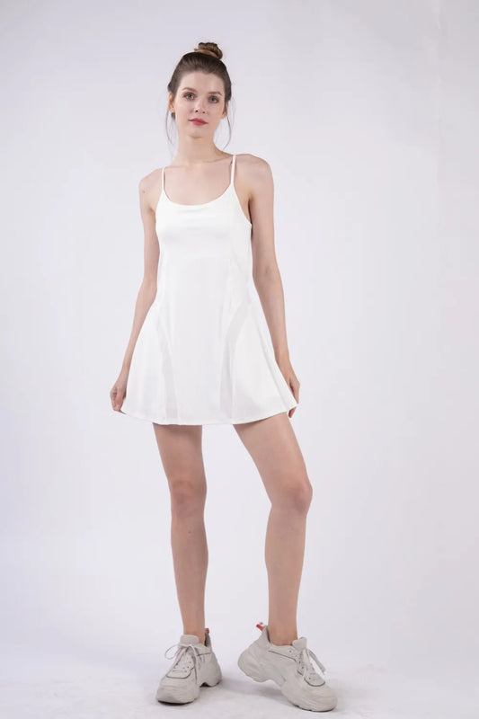 Woman wearing the Her Femme Fit Mesh Panel Tennis Dress in White