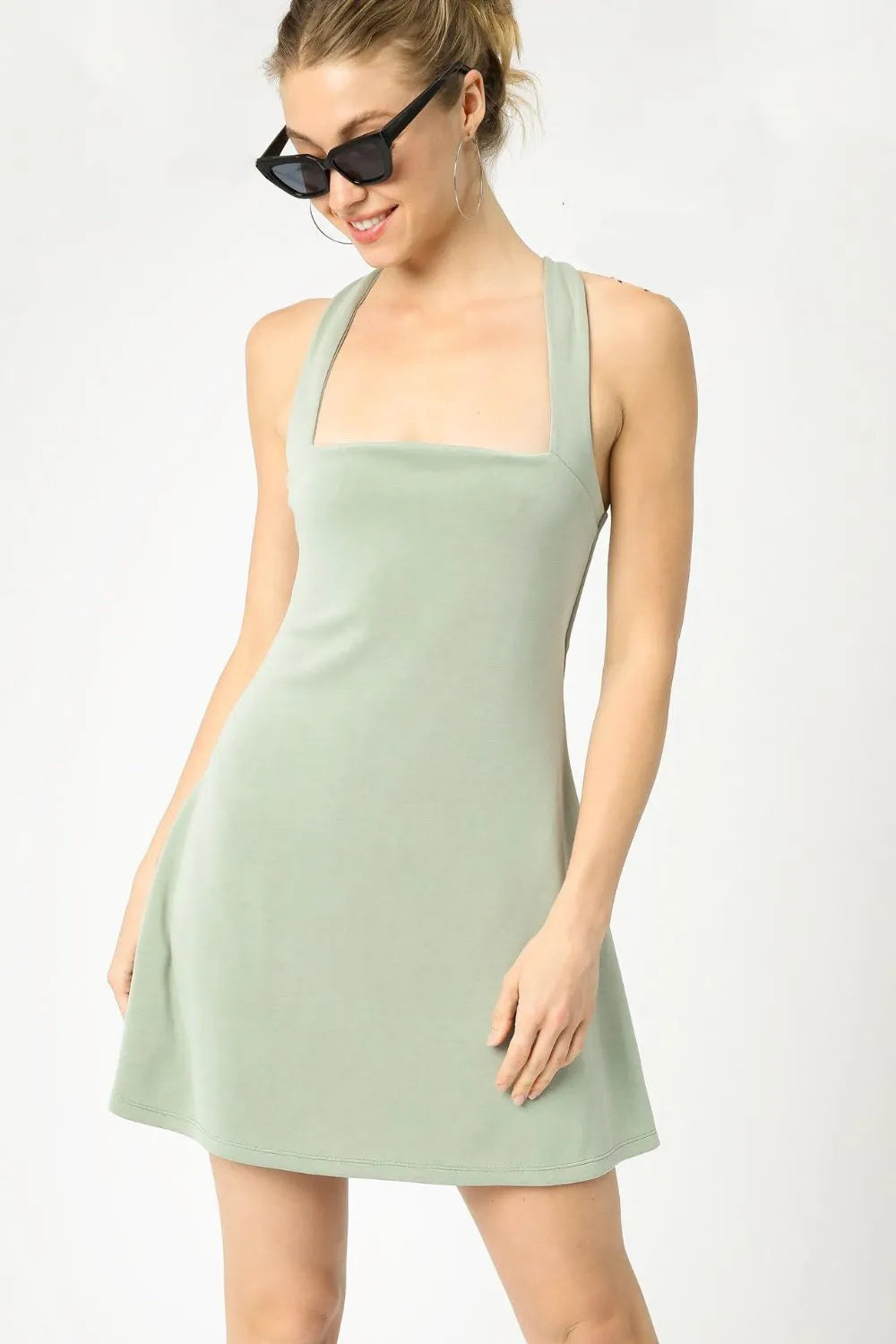 Woman wearing the Her Femme Fit Crisscross Square Neck Active Dress in Sage