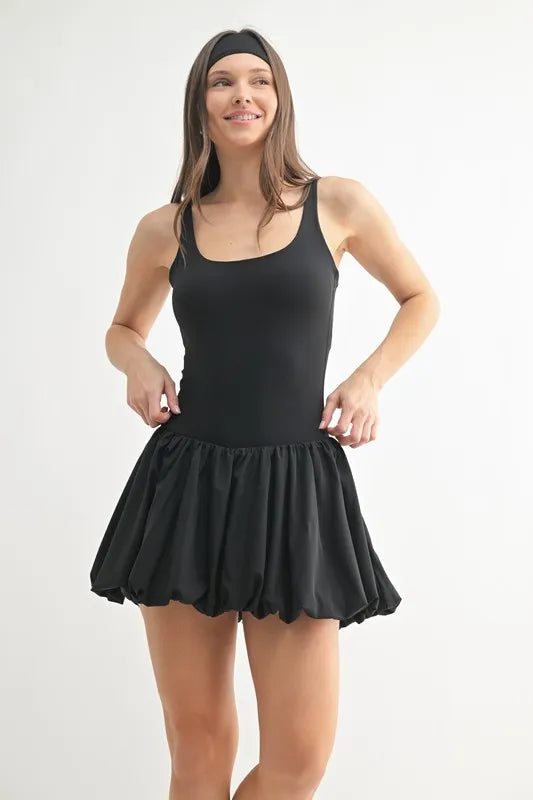 Woman wearing the Her Femme Fit Bubble Hem Active Mini Dress in Black
