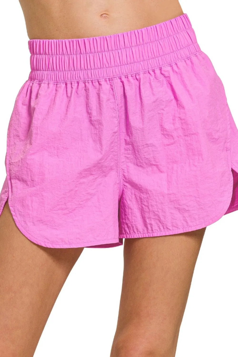 Woman wearing the Her Femme Fit Windbreaker Running Shorts in Bright Mauve