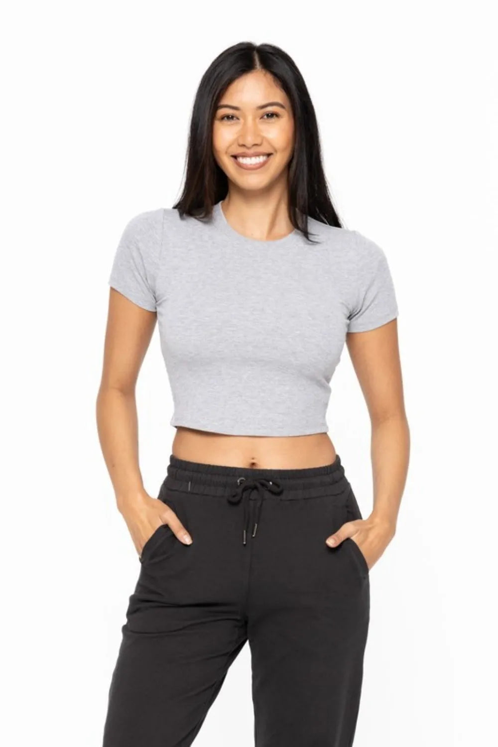 Woman wearing the Her Femme Fit Micro-Ribbed Cropped Tee in Heather Grey