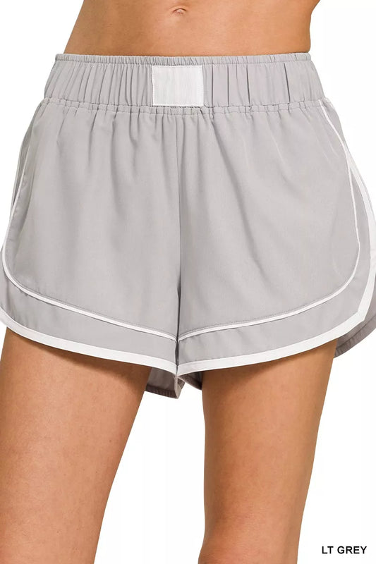 Woman wearing the Her Femme Fit Lined Dolphin Shorts in Light Grey