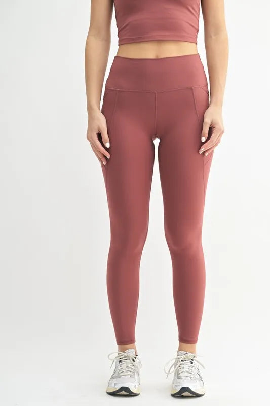 Woman wearing the Her Femme Fit Cloud Sculpt High-Rise Leggings in Red Pear